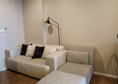 Living room with a modern couch and floor lamp