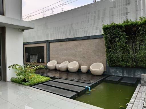 Modern outdoor patio with water feature and seating area