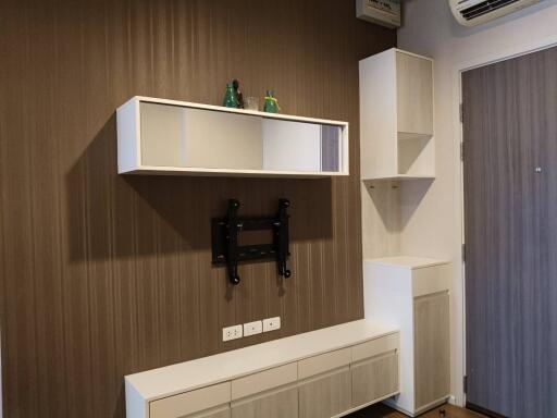 Modern living room with wall-mounted shelves and air conditioning