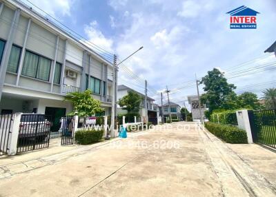 Residential area with multiple houses and greenery.