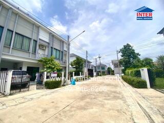 Residential area with multiple houses and greenery.