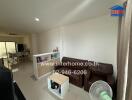 Living room with brown sofa, small coffee table, and partition showcasing decorative items