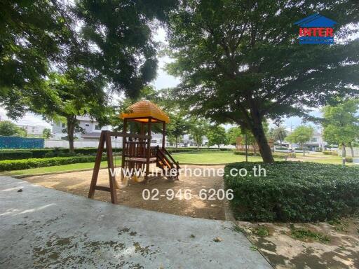 Playground area with slide beneath shade trees