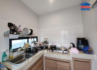 Modern kitchen with sink, countertops, and appliances