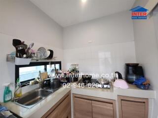 Modern kitchen with sink, countertops, and appliances