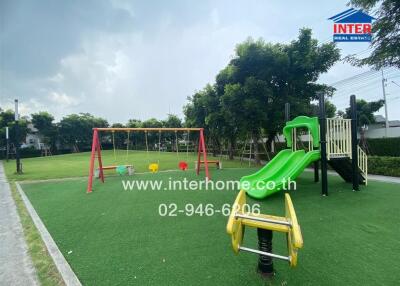 Outdoor playground with swings, slide, and play equipment