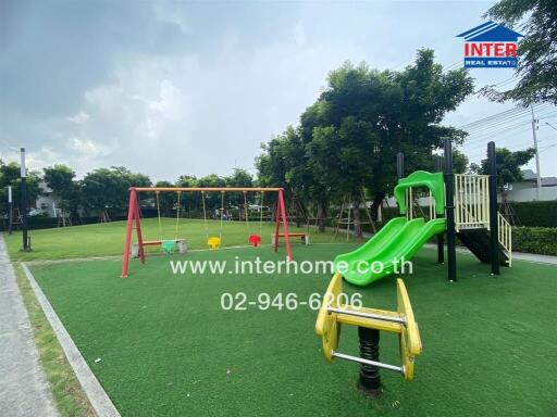 Outdoor playground with swings, slide, and play equipment