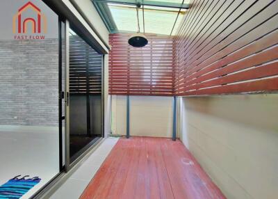 Enclosed balcony with wooden floor and slatted wooden wall