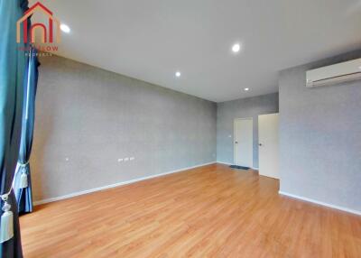 Spacious living room with wooden floor and air conditioning