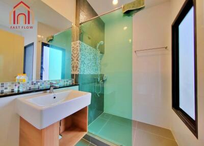 Modern bathroom with glass shower and large window