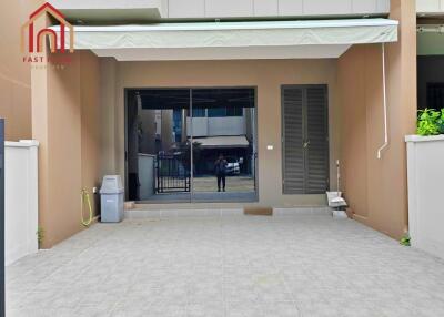 Front entrance of a modern property with a tiled driveway and sliding door