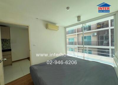 Bedroom with large window and balcony view