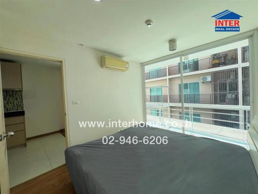 Bedroom with large window and balcony view