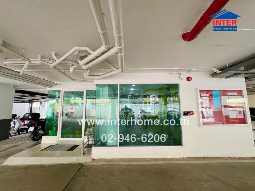 building entrance with glass doors and exterior view of pipes