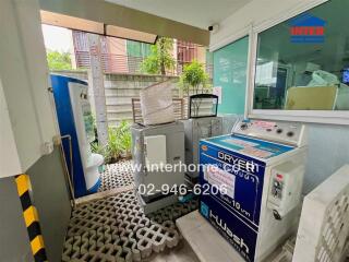 Outdoor laundry area with washing machines