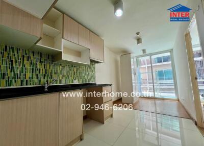 Modern kitchen with ample storage space and balcony access