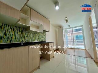 Modern kitchen with ample storage space and balcony access