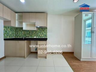 Modern kitchen area with wooden cabinets and green mosaic backsplash