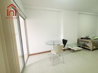 Minimalist living area with glass table and chairs