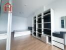 Modern bedroom with wooden flooring and built-in shelves