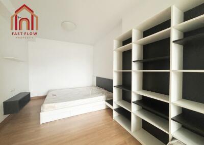 Spacious bedroom with bed and built-in shelving