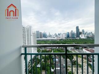 View from balcony overlooking cityscape with high-rise buildings