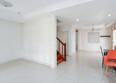 Spacious living area with staircase and dining area