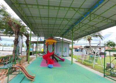 Covered playground area with slides and play equipment