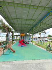 Covered playground area with slides and play equipment