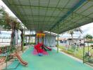 Covered playground area with slides and play equipment