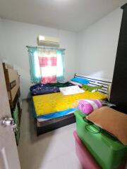 Small bedroom with air conditioner and storage boxes