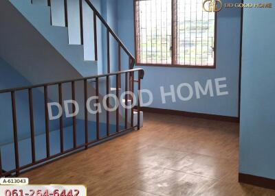 Staircase and landing area with window and blue walls