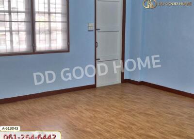 Empty bedroom with wooden floor and blue walls