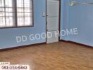 Empty bedroom with wooden floor and blue walls