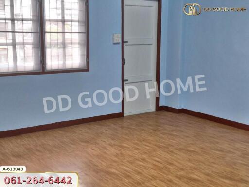 Empty bedroom with wooden floor and blue walls