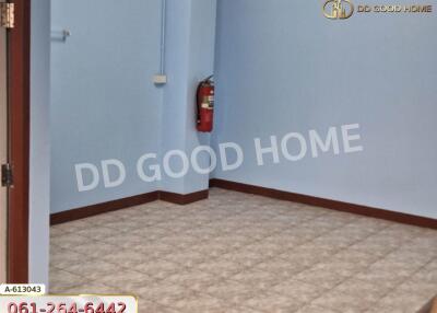 empty room with tiled floor and fire extinguisher on the wall