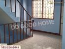 Indoor staircase with blue walls and decorative railing