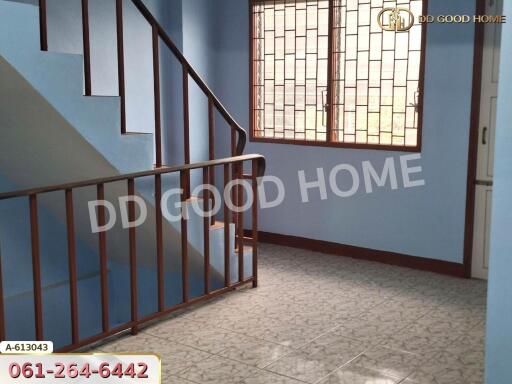 Indoor staircase with blue walls and decorative railing