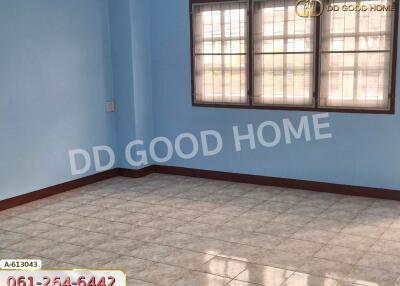 Empty bedroom with tiled floor and large windows