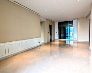 Spacious living room with marble flooring and large windows