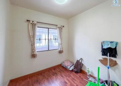 Small bedroom with window and wooden floor