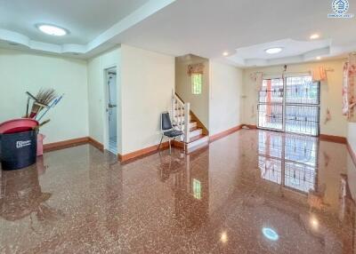 Spacious living room with marble floor and staircase