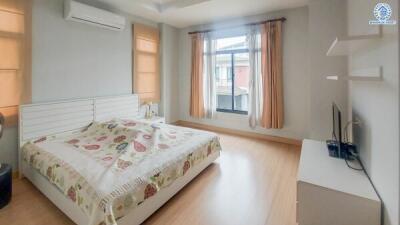 Bedroom with wooden flooring, natural light, and air conditioning