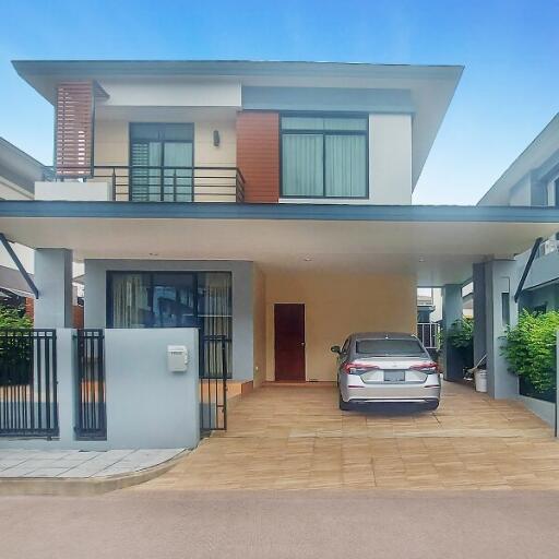 Modern two-story house with a car in the driveway