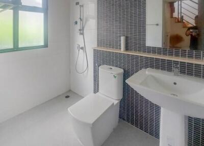 Modern bathroom with large window and black tiled wall