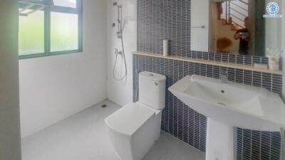 Modern bathroom with large window and black tiled wall