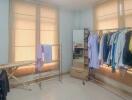 Bedroom with clothing racks and ironing board