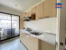 Kitchen area with counter, cabinets, and a view of the balcony