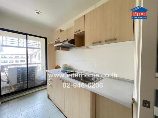 Kitchen area with counter, cabinets, and a view of the balcony