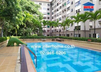 Outdoor swimming pool area in a residential building complex